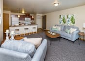 Thumbnail 2 of 35 - a living room with couches and a table at Melbourne Apartments, Des Moines, IA