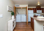 Thumbnail 7 of 35 - a kitchen with white appliances and a counter top at Melbourne Apartments, Des Moines, Iowa
