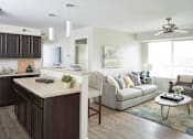 Thumbnail 1 of 56 - a living room and kitchen with a couch and a table at Meadowlark Place Apartments, Iowa, 50111