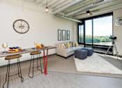 Thumbnail 6 of 42 - a living room with a couch and a desk and a large window at Eagle View Lofts, Iowa, 50309
