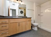Thumbnail 21 of 42 - a bathroom with a toilet and a sink and a mirror at Eagle View Lofts, Des Moines, IA, 50309