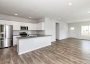 Thumbnail 1 of 21 - A modern kitchen with wooden floors and stainless steel appliances. at Two Rivers Home Rentals, West Des Moines, 50266