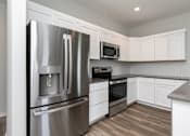 Thumbnail 6 of 21 - a kitchen with a stainless steel refrigerator at Two Rivers Home Rentals, West Des Moines, IA