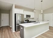 Thumbnail 7 of 21 - a large kitchen with a white counter top at Two Rivers Home Rentals, West Des Moines, Iowa