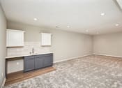 Thumbnail 11 of 21 - an empty living room with a sink and a kitchen at Two Rivers Home Rentals, West Des Moines