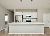 Thumbnail 14 of 21 - an empty kitchen with a white counter top at Two Rivers Home Rentals, West Des Moines, 50266