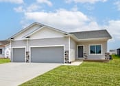 Thumbnail 15 of 21 - a white house with a driveway and a garage door at Two Rivers Home Rentals, West Des Moines, Iowa