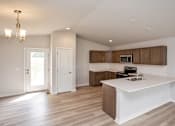 Thumbnail 16 of 21 - an empty kitchen with a white counter top at Two Rivers Home Rentals, West Des Moines