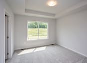 Thumbnail 20 of 21 - A room with a large window and a carpeted floor. at Two Rivers Home Rentals, Iowa