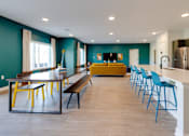 Thumbnail 10 of 28 - A kitchen with blue chairs and a table.