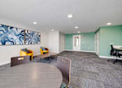 Thumbnail 11 of 28 - A room with a large painting on the wall and a carpeted floor.