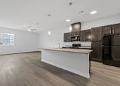 Thumbnail 42 of 52 - A kitchen with a white island and dark brown cabinets.