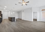 Thumbnail 4 of 52 - A spacious room with a ceiling fan and lighting fixtures.