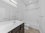 Thumbnail 15 of 52 - A white bathroom with a sink, toilet, and bathtub.
