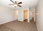 Thumbnail 4 of 90 - a spacious living room with carpet and a ceiling fan at Rosemont Place Apartments, Iowa, 50320