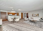 Thumbnail 1 of 40 - a living room with a couch and a table at Autumn Park, Sioux Falls, SD  