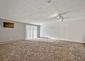 Thumbnail 36 of 40 - an empty living room with carpet and a ceiling fan at Autumn Park, Sioux Falls South Dakota  