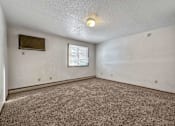 Thumbnail 35 of 40 - an empty living room with carpet and a window at Autumn Park, South Dakota, 57106