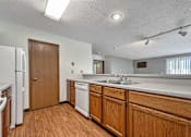Thumbnail 9 of 40 - a kitchen with wooden cabinets and a sink and a refrigerator at Autumn Park, Sioux Falls South Dakota  