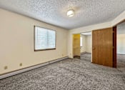 Thumbnail 14 of 40 - an empty living room with a door and a window at Autumn Park, Sioux Falls, SD  