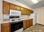 Thumbnail 10 of 40 - a kitchen with a stove microwave and refrigerator at Autumn Park, Sioux Falls, SD 57106  