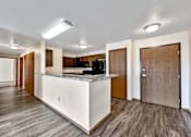 Thumbnail 25 of 40 - a kitchen with a counter top and a refrigerator at Autumn Park, Sioux Falls, SD  