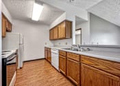 Thumbnail 11 of 40 - a kitchen with wooden cabinets and a sink and a refrigerator at Autumn Park, Sioux Falls, 57106  