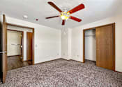 Thumbnail 23 of 40 - a bedroom with a ceiling fan and a closet at Autumn Park, South Dakota, 57106