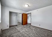 Thumbnail 29 of 40 - a room with carpet and a door to a closet at Autumn Park, South Dakota  