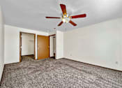 Thumbnail 21 of 40 - a living room with carpet and a ceiling fan at Autumn Park, Sioux Falls South Dakota  