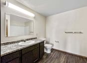 Thumbnail 24 of 40 - a bathroom with a sink toilet and a mirror at Autumn Park, Sioux Falls, SD 57106  