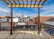 Thumbnail 19 of 37 - A wooden pergola is over a concrete patio.