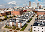 Thumbnail 33 of 37 - A cityscape with buildings and a clear sky.