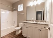 Thumbnail 14 of 37 - A white bathroom with a toilet, sink, and shower.
