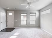 Thumbnail 3 of 37 - A room with a ceiling fan and a window.