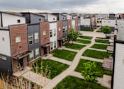 Thumbnail 35 of 37 - A row of modern townhouses with a pathway between them.
