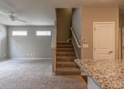 Thumbnail 16 of 37 - A room with a staircase leading to the second floor.