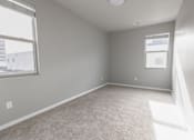 Thumbnail 17 of 37 - A room with a carpeted floor and a window letting in sunlight.