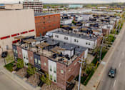 Thumbnail 25 of 37 - Apartment complex with a mix of brick and white buildings.