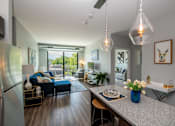 Thumbnail 21 of 30 - an open living room and dining room with a kitchen counter and a living room at Soll, Des Moines, IA 50312  