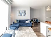 Thumbnail 20 of 30 - a living room with a blue couch and a kitchen at Soll, Iowa, 50312