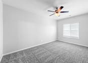 Thumbnail 3 of 7 - A room with a ceiling fan and a window with blinds.