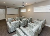 Thumbnail 38 of 50 - A room with grey striped chairs and a whiteboard on the wall.