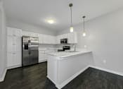 Thumbnail 3 of 50 - an empty kitchen with white cabinets and a stainless steel refrigerator at Stonegate Crossing Apartments, Clive, IA