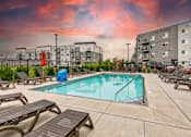 Thumbnail 10 of 13 - our apartments have a pool and lounge chairs at our apartments at Lake Shore Place Apartments, Iowa