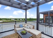 Thumbnail 10 of 77 - Rooftop terrace with pergola and outdoor sectional sofa at The Flats at West Glen Apartments, Iowa