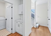 Thumbnail 77 of 77 - Upper floor hallway with laundry and cabinetry at The Flats at West Glen Apartments, Iowa, 50266
