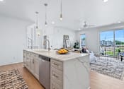 Thumbnail 6 of 77 - White waterfall island with dishwasher and pendant lights at The Flats at West Glen Apartments, West Des Moines, 50266