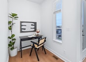 Thumbnail 75 of 77 - Home office nook with black desk and woven chair at The Flats at West Glen Apartments, West Des Moines, Iowa