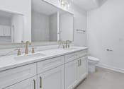 Thumbnail 68 of 77 - Bathroom with dual vanity and champagne bronze faucets at The Flats at West Glen Apartments, West Des Moines, IA 50266